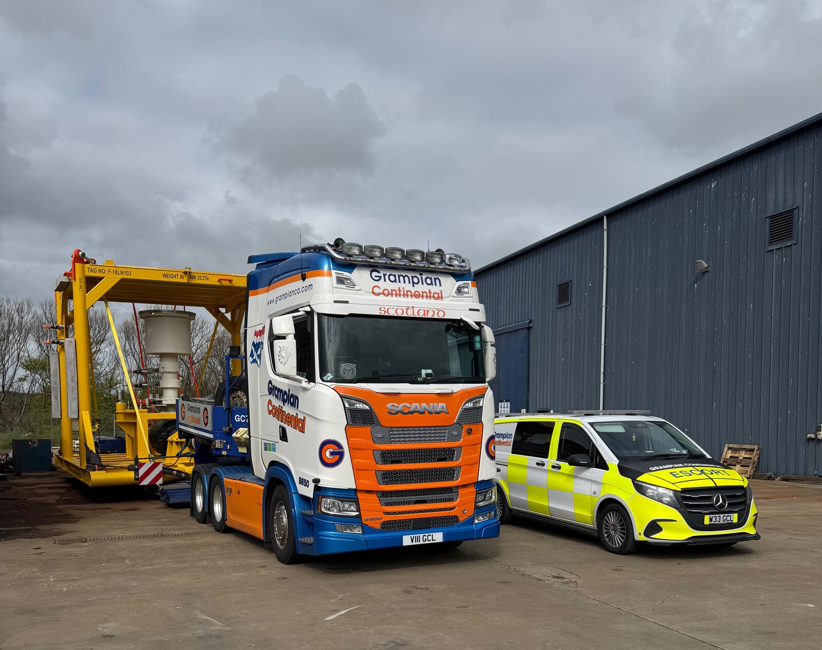 Grampian Continental truck and escort vehicle at the depot